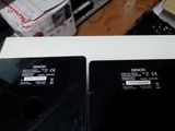 two laptops sitting next to each other on a table