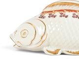 a white fish shaped container with gold trimming on it