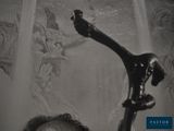 a black and white photo of a man holding a hair dryer