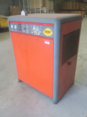 an orange and grey oven sitting in a warehouse