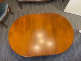 a wooden table with a blue chair in the corner