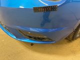 a close up of a blue car with a sticker on it