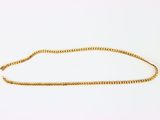 a gold chain on a white background