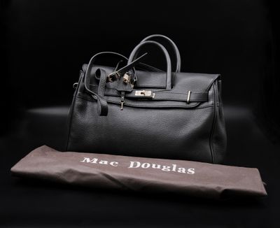 a black leather handbag and an umbrella on a black background
