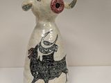 a small vase with a picture of a cow on it