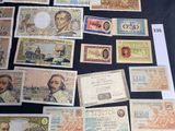 several different types of paper money laid out on a table