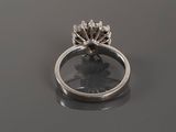 a close up of a ring with a flower on top of it