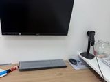 a computer desk with a monitor, keyboard and mouse on it