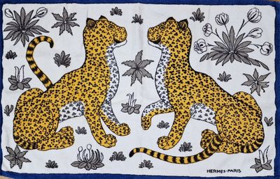 two cheetah cats on a blue background with flowers and butterflies