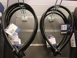 two black hoses hanging on a wall in a store