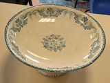 a large bowl sitting on a table with a blue and white design