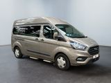 the silver van is parked in a large room with a black floor
