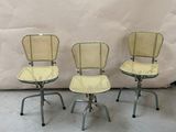 three chairs sitting on top of each other in front of a white backdrop