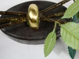 a gold sculpture of a spider sitting on a rock