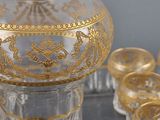 a glass jar with a gold decoration on top of it