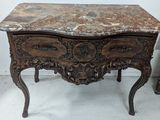 a marble top table with a drawer underneath it