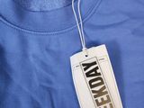 a blue t - shirt with a white tag on it