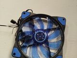 a blue and white fan sitting on a white table