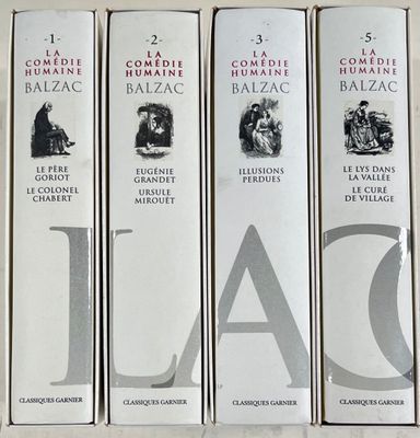 quatre livres sont alignés sur une table