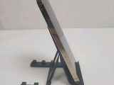 a cell phone that is on a stand on a table