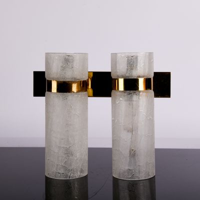 two clear glass vases sitting on top of a black table