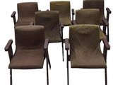six brown chairs are arranged in a circle on a white background
