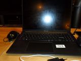 a laptop that is sitting on a table with a charger on it