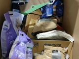 a cardboard box filled with bags of food and other items