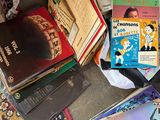 a pile of books on the floor next to a pile of other books