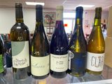several bottles of wine are lined up on a counter in a store