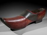 an old wooden clogger with a red and black color scheme