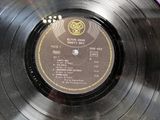 an old record with a label on it sitting on top of a table