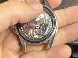 a person that is holding a watch in their hand