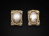 a pair of gold and pearl earrings with diamonds