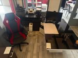 a desk with a chair and a computer on it