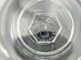 a close up of a glass of water with a black and white image of a skull