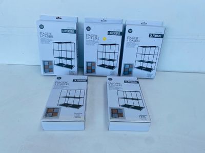 four boxed boxes of makeup products sitting on a white surface