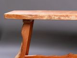 a wooden bench that is sitting on the floor