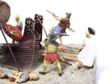 figurines of a group of people with spears and shields in a field