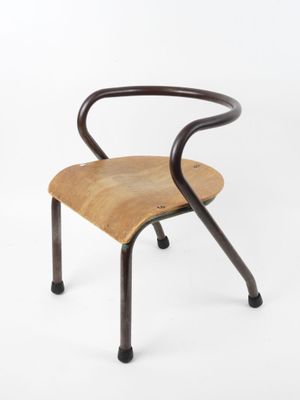 an image of a wooden chair with black legs and a bent back