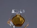a bottle of perfume sitting on top of a table