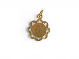 a gold plated pendant with a flower design on it