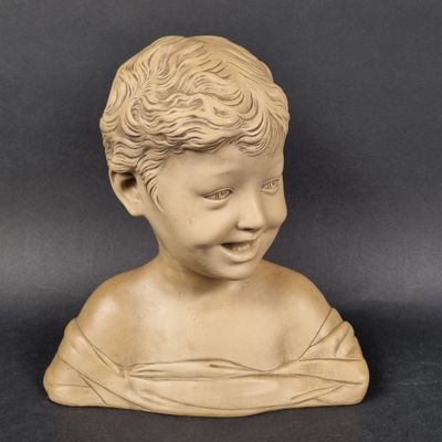 marble bust of a boy with curly hair on a black background