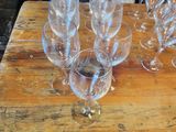 several empty wine glasses on a wooden table with a price tag