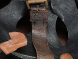 a close up of a helmet with a leather strap