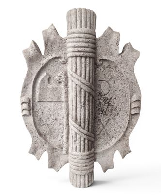 a stone sculpture of a pencil and gear on a white background