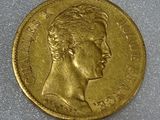 a close up of a gold coin with a woman ' s face on it