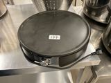 a large frying pan sitting on a table in a kitchen