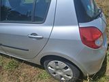 a small silver car that is parked in the grass