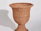 a wicker vase that is sitting on a table
